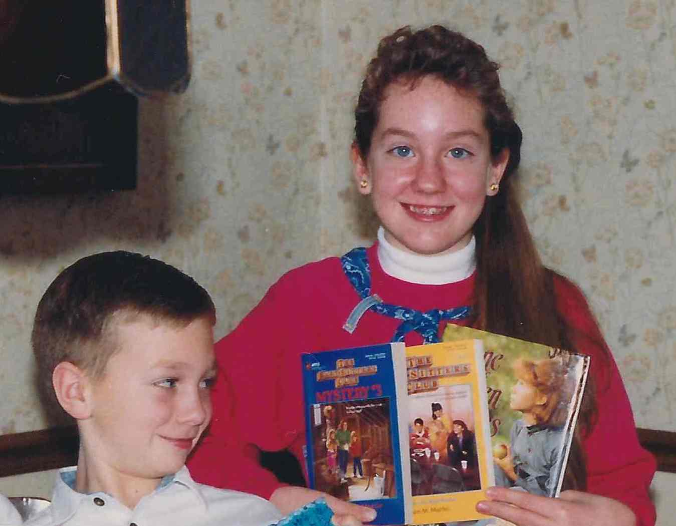 Doesn't my little brother look amused that I'm excited about the new books I got for my birthday?